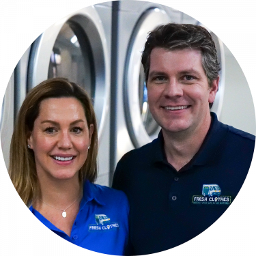 Fresh Clothes Mobile Laundry Founders Matt and Tamara Krebs pose in front of laundry machines